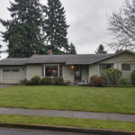 Photorealistic exterior of a modest post-1950s ranch-style home in Salem, Oregon, with muted siding, a low roofline, attached garage, mature evergreen trees, damp sidewalk, and a green front lawn on an overcast Pacific Northwest day.